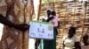 A health worker explains birth control at a clinic outside Juba, South Sudan. (H. McNeish for VOA)