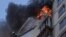 Firefighters work to put out a fire in a residential apartment building after it was hit by shelling in Kyiv