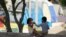 FILE - In this Nov. 18, 2020, photo, children play at a camp of asylum seekers stuck at America's doorstep, in Matamoros, Mexico. 