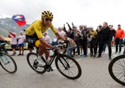 Colombia's Egan Bernal wearing the overall leader's yellow jersey climbs toward Val Thorens during the twentieth stage of the Tour de France, July 27, 2019.