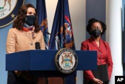 Governor Gretchen Whitmer addresses the state as Michigan Department of Health and Human Services Chief Medical Executive Dr. Joneigh Khaldun, right, listens, April 9, 2021, in Lansing. (Michigan Office of the Governor)