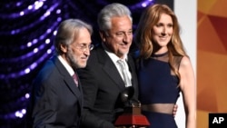 Neil Portnow, president and CEO of the Recording Academy, from left, Trustees Award recipient Humberto Gatica and Celine Dion pose on stage at the Lifetime Achievement and Trustees Awards presentation at the Ka Theater in the MGM Grand Hotel, Nov. 18, 2015.