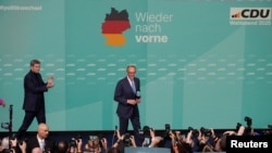 German conservative candidate for chancellor and Christian Democratic Union party leader Friedrich Merz walks on stage after the exit poll results are announced in the German general elections in Berlin, Feb. 23, 2025.