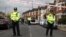 FILE - Police stand next to terraced housing in Harlesden Road, north London, April 28, 2017. British counterterrorism police said they had thwarted an active plot in an armed raid, the second major security operation in the British capital in the space of a few hours.