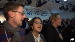 In this image made from video, protesters sing during climate talks at the World Climate Conference in Bonn, Germany, Nov. 13, 2017.