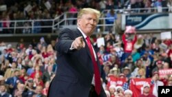 FILE - President Donald Trump points to a supporter as he departs a rally at the Mississippi Coast Coliseum in Biloxi, Miss., Nov. 26, 2018. Trump’s campaign has launched a state-by-state effort to prevent an intraparty fight. 