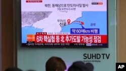 Visitors sit in front of the TV screen showing a news program reporting about North Korea's missile firing, at Seoul Train Station in South Korea, April 5, 2017. North Korea fired a ballistic missile into its eastern waters Wednesday.