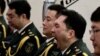 A member of military music band yawns while others listen to Chinese Premier Wen Jiabao's work reports speech at the opening session of the annual National People's Congress at Beijing's Great Hall of the People, March 5, 2013.