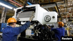 FILE - Workers assemble trucks at GAZ car factory in Nizhny Novgorod, Russia, June 17, 2009. 