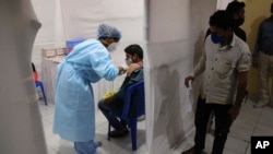 A health worker administers the vaccine for COVID-19 in Mumbai, India, Aug. 19, 2021.