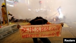 A protester holds a banner during a demonstration in Mong Kok district in Hong Kong, China.