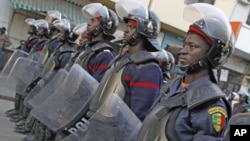 Riot policemen stand in a row to block access to Independence Square during an opposition demonstration against Senegal's President Abdoulaye Wade's controversial third term bid for presidency in Dakar February 24, 2012.