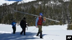 Frank Gehrke, chief of the California Cooperative Snow Surveys Program for the Department of Water Resources, carries the snowpack survey tube as he crosses a meadow during the third manual snow survey of the season at Phillips Station near Echo Summit, California, March 1, 2017.