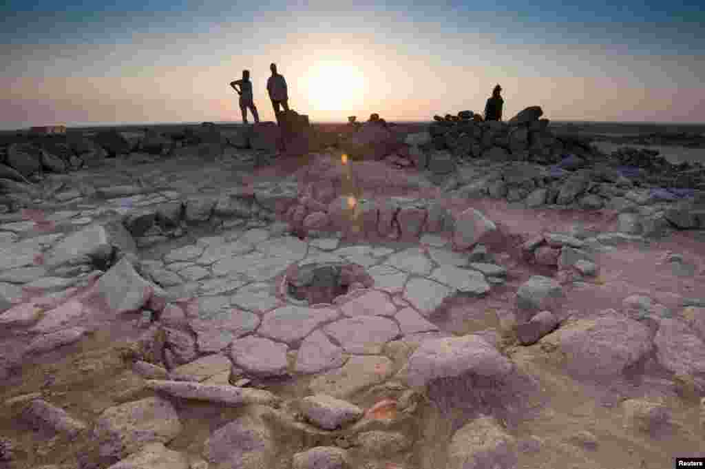 A stone structure can be seen at an archaeological site containing a fireplace, pictured in the middle, where charred remains of 14,500-year-old bread was found in the Black Desert, in northeastern Jordan, in this photo provided on July 16, 2018.