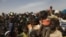 FILE - Displaced children wait for help at a village of Dablo area, Burkina Faso, March 2, 2019. 