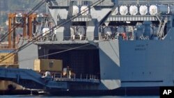 A truck carrying a container from the Danish vessel Ark Futura drives into the hold of the U.S.- owned MV Cape Ray, at Gioia Tauro port, southern Italy, July 2, 2014. 