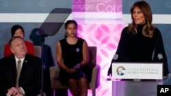 First lady Melania Trump speaks during the 2020 International Women of Courage Awards Ceremony at the State Department in Washington, Feb. 4, 2020, as Secretary of State Mike Pompeo, seated left, looks on. 