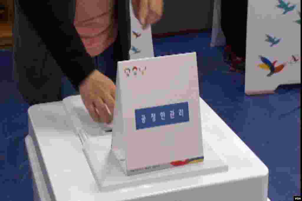 Voters approach a ballot box in South Korea's election.