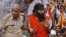 An Indian senior policeman detains yoga guru Baba Ramdev, right, during an anti-corruption protest in New Delhi, India, August 13, 2012. 