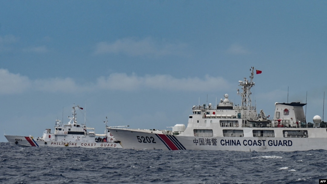Một tàu Hải cảnh Trung Quốc (phải) đi ngang qua tàu của Cảnh sát biển Philippines BRP Cape Engaño (trái), được chụp từ tàu BRP Cabra trong một nhiệm vụ tiếp tế cho Bãi cạn Sabina ở vùng biển tranh chấp tại Biển Đông, ngày 26 tháng 8 năm 2024.
