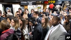 FILE - Commuters exit a subway in New York City. May, 16, 2016. (AP Photo/Mark Lennihan)