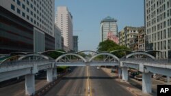 A car is seen on an empty street in downtown Yangon, Myanmar, March 24, 2021, during what anti-coup protesters called a "silent strike."