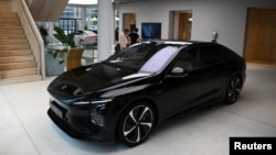 FILE - An NIO ET7 car model is presented at the NIO House, the showroom of the Chinese premium smart electric vehicle manufacturer NIO Inc. in Berlin, Germany, Aug. 17, 2023.