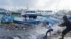 Fishermen pull a boat damaged by Hurricane Beryl back to the dock at the Bridgetown Fisheries in Barbados, July 1, 2024.
