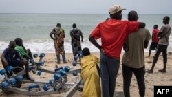 Family members, friends and community members gather along the beach as they wait for search and rescue teams to find survivors and retrieve the dead after a boat carrying migrants sunk off Mbour, Senegal, on Sept. 9, 2024. 