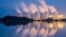 FILE - In this Sept. 19, 2018 photo steam and cooling towers of a lignite power plant are reflected in a pond in Peitz, eastern Germany. 