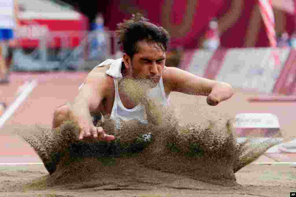 Afghanistan&#39;s Hossain Rasouli competes in the men&#39;s T47 long jump during the 2020 Paralympics at the National Stadium in Tokyo, Japan.