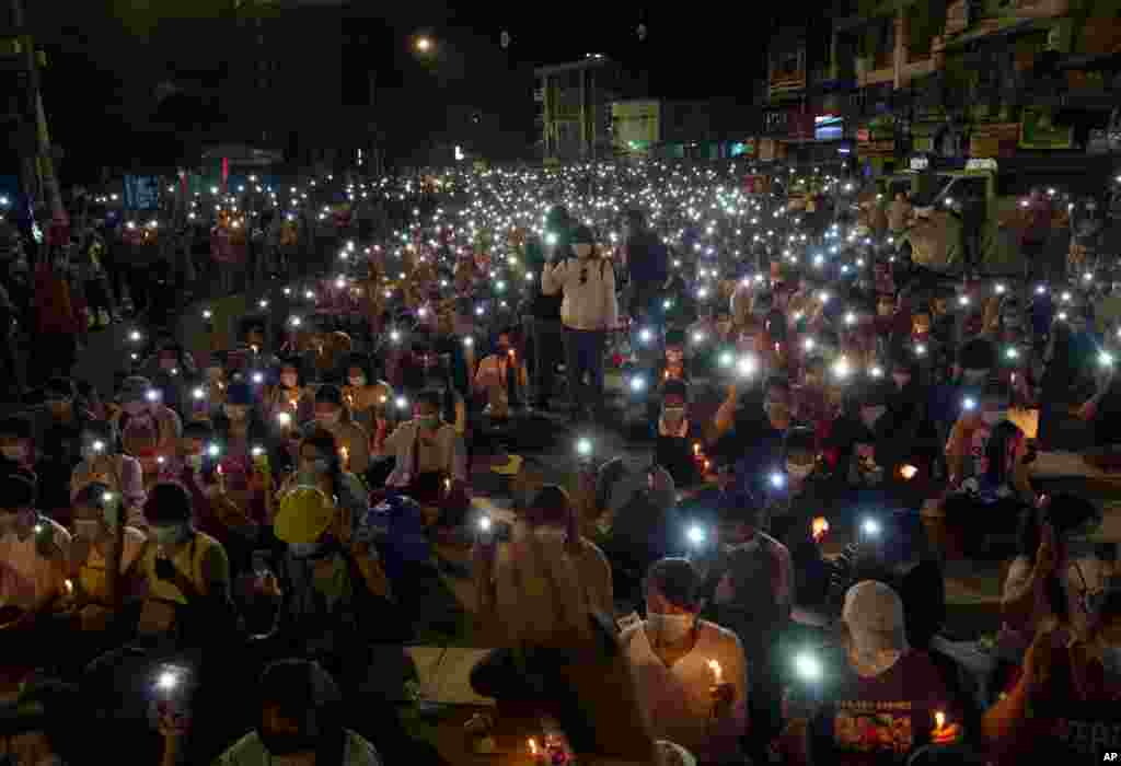 Anti-coup protesters turn on the LED light of their mobile phones during a candlelight night rally in Yangon, Myanmar.