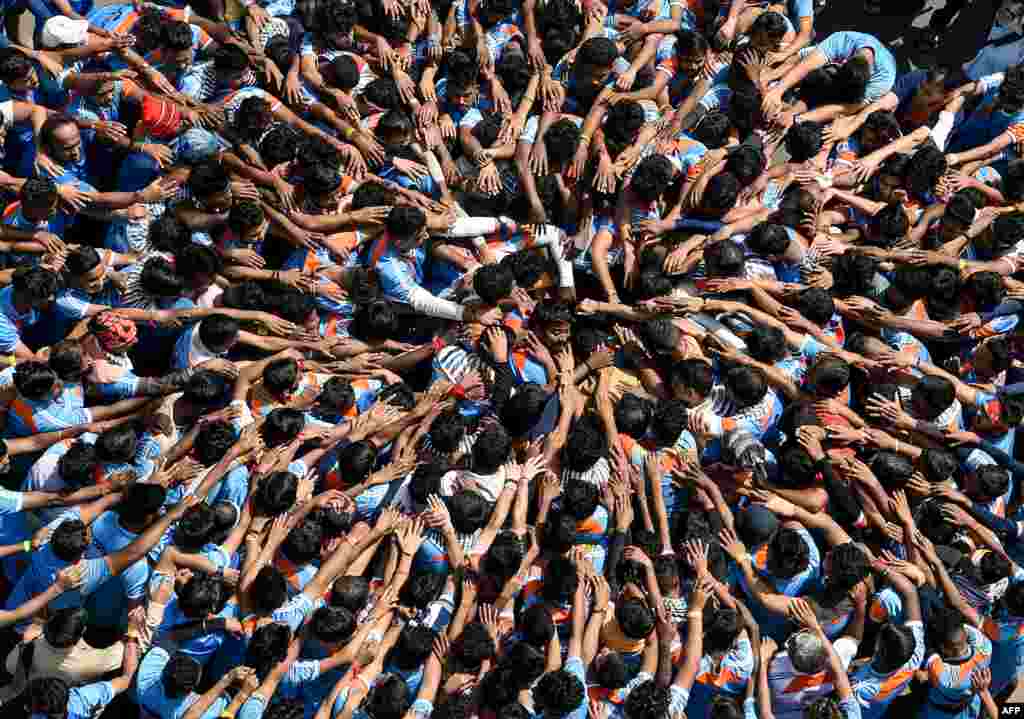Hindu devotees take a vow before forming a human pyramid during celebrations for the &#39;Janmashtami&#39; festival, which marks the birth of Hindu God Lord Krishna, in Mumbai, India, Aug. 24, 2019.