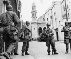 FILE - French troops seal off the historic casbah quarter, in Algiers, Algeria, May 27, 1956.
