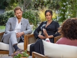 This undated image released March 7, 2021 courtesy of Harpo Productions shows Britain's Prince Harry (L) and his wife Meghan (C), Duchess of Sussex, in a conversation with US television host Oprah Winfrey. - Britain's royal family on March 7, 2021…