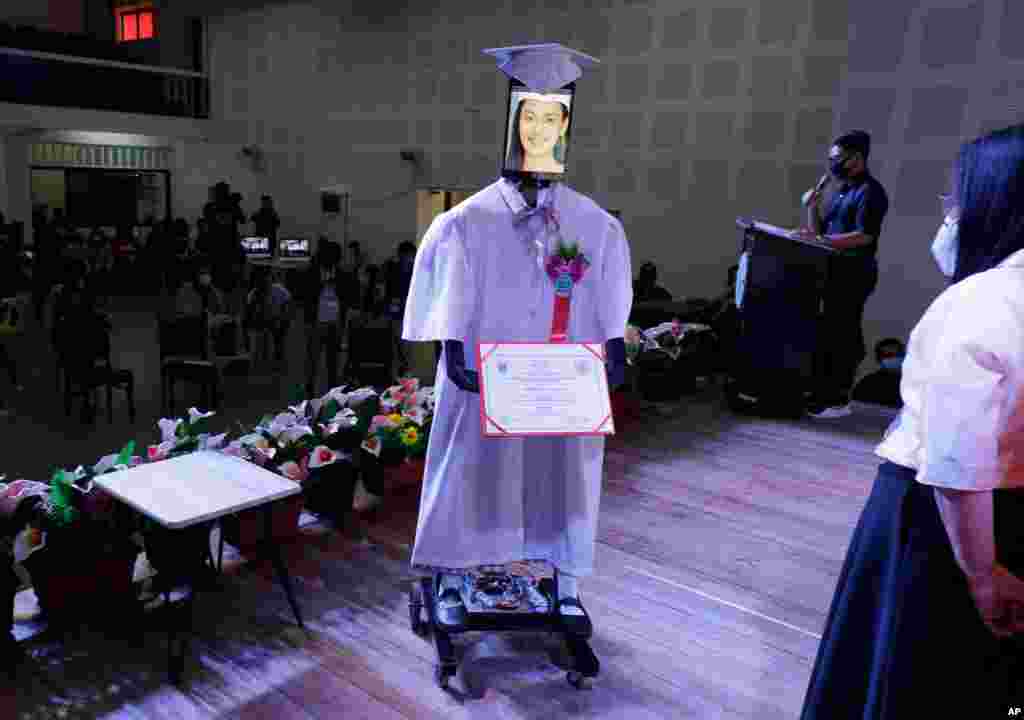 A picture of a student is seen on a tablet that is placed on a robot during an event they called "cyber-graduation" at a school at Taguig in Manila, Philippines.