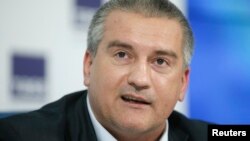 FILE - Crimean leader Sergei Aksyonov has caused a stir by traveling with Russian President Vladimir Putin to a summit in India.