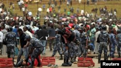 Federal Police assists protestors injured following the burial ceremony of Simegnew Bekele, 