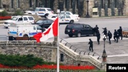 Pasukan bersenjata Kanada mendekati Gedung parlemen menyusul penembakan di Ottawa (22/10). PM Kanada, Stephen Harper terpaksa membatalkan acara untuk Malala Yousafzai pada hari iru.