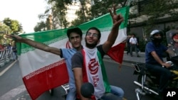 Iranians attend a street celebration in Tehran, after their national soccer team qualified for the 2014 World Cup by defeating South Korea, June 18, 2013. 
