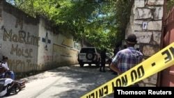 Journalists stand by a yellow police cordon near the residence of Haiti's President Jovenel Moise after he was shot dead by unidentified attackers, in Port-au-Prince, Haiti, July 7, 2021.