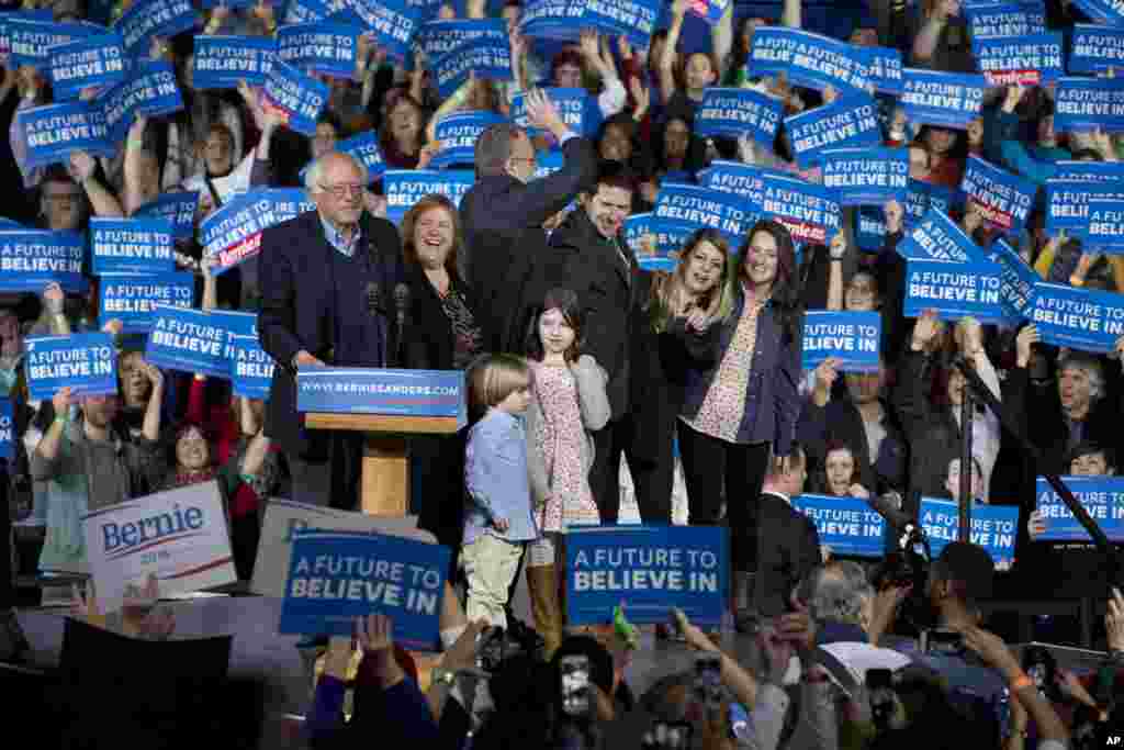 Democratic presidential candidate Sen. Bernie Sanders, I-Vt., his wife Jane Sanders, his son Levi Sanders, and members of their family arrive to cheers during a primary night rally in Essex Junction, Vermont, March 1, 2016.