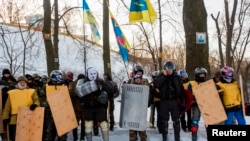 Members of various anti-government paramilitary groups attend a religious service at a chapel in Kyiv, January 29, 2014. 