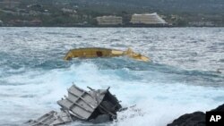 This photo provided by the Hawaii Dept. of Land and Natural Resources shows a portion of a capsized vessel. The first storm of the hurricane season sent Hawaii into hurried preparation mode, but residents got through the weekend without seeing major damage as the storm was downgraded, officials said Monday, July 25, 2016.