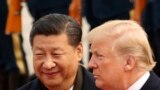 FILE - U.S. President Donald Trump and Chinese President Xi Jinping participate in a welcome ceremony at the Great Hall of the People in Beijing, China, Nov. 9, 2017.