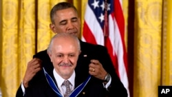 President Barack Obama awards chemist, and Nobel Prize winner Mario Molina with the Presidential Medal of Freedom during a ceremony in the East Room of the White House in Washington, Nov. 20, 2013.