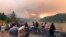 People at a viewpoint overlooking the Columbia River watching the Eagle Creek wildfire burning in the Columbia River Gorge east of Portland, Ore., Sept. 4, 2017.