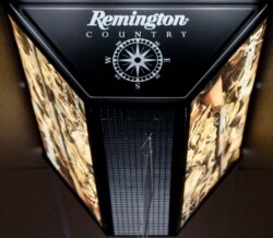 FILE - In this March 1, 2018, photo, a light advertising Remington products hangs from the ceiling at Duke's Sport Shop in New Castle, Pa.