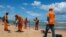 Municipality workers clean oil at a beach in Lauro de Freitas, Bahia state, Brazil, on November 2, 2019.