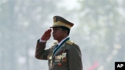 Burmese Gen. Min Aung Hlaing salutes the national flag during a ceremony marking the country's 67th Armed Forces Day in Naypyitaw, Burma, March 27, 2012. 